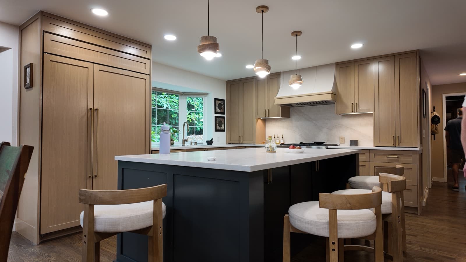 Custom white-oak cabinetry maximizing storage in a remodeled Bellevue kitchen